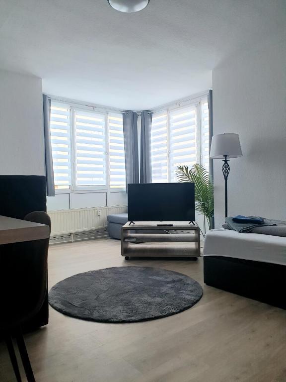 a living room with a couch and a chair at Zur Elster 2 in Plauen