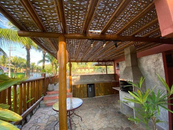 an outdoor patio with a grill and a stove at Condomínio Mata Azul in São Sebastião