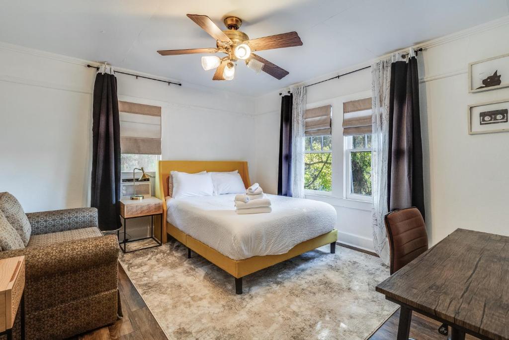 a bedroom with a bed and a ceiling fan at Jefferson Flat - Master Room in Lafayette