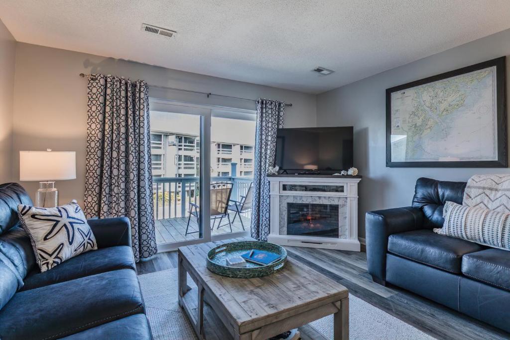 a living room with a couch and a table at NEW LISTING! Ocean and Pool Views on Harbor Island - Short Walk to Pool and Beach in Harbor Island