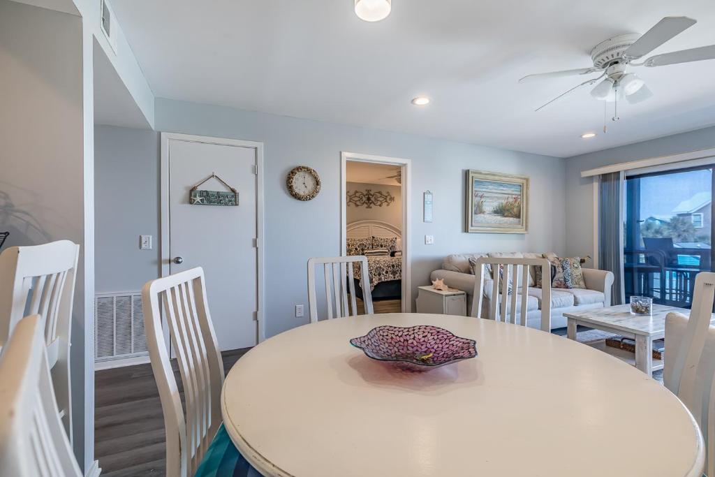 a dining room and living room with a table and chairs at Direct Ocean View! M Building Pool and Ocean Views in Harbor Island