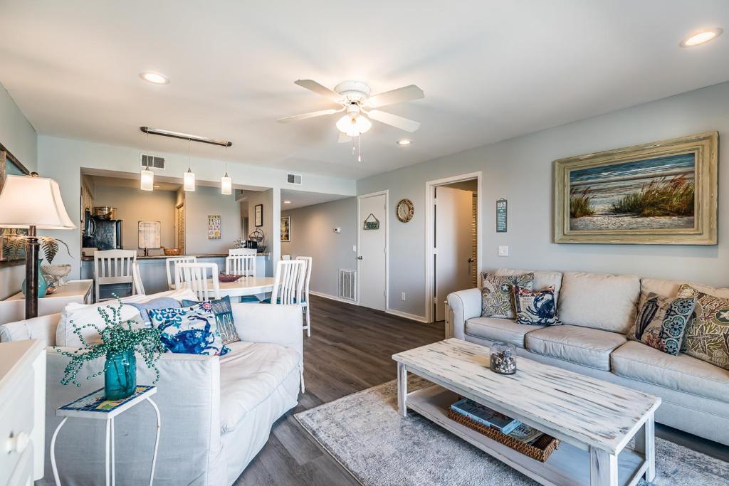 a living room with a couch and a table at Direct Ocean View! M Building Pool and Ocean Views in Harbor Island