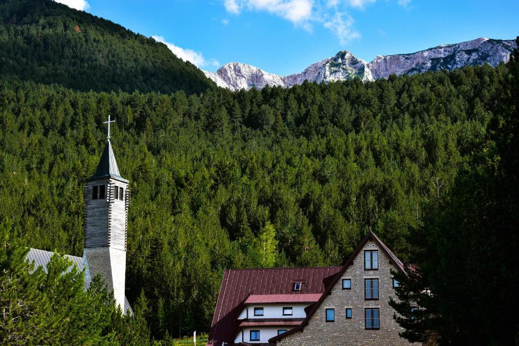 a church with a cross on the top of a mountain at Villa Anemar in Blidinje