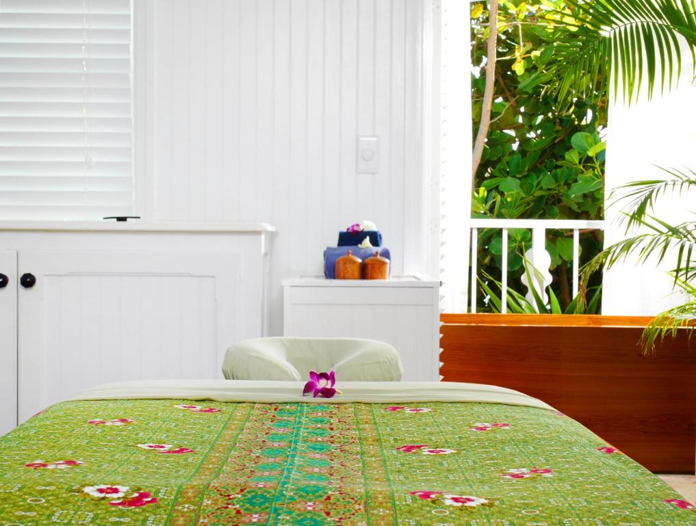 a bedroom with a bed with a pink bow on it at Ocean Key Resort & Spa, a Noble House Resort in Key West