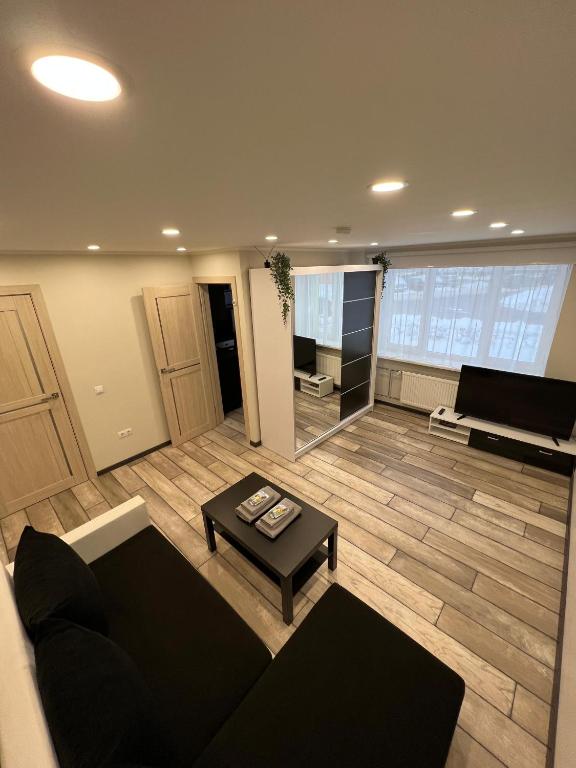 a living room with a couch and a table at Valmiera City Centre Apartment in Valmiera