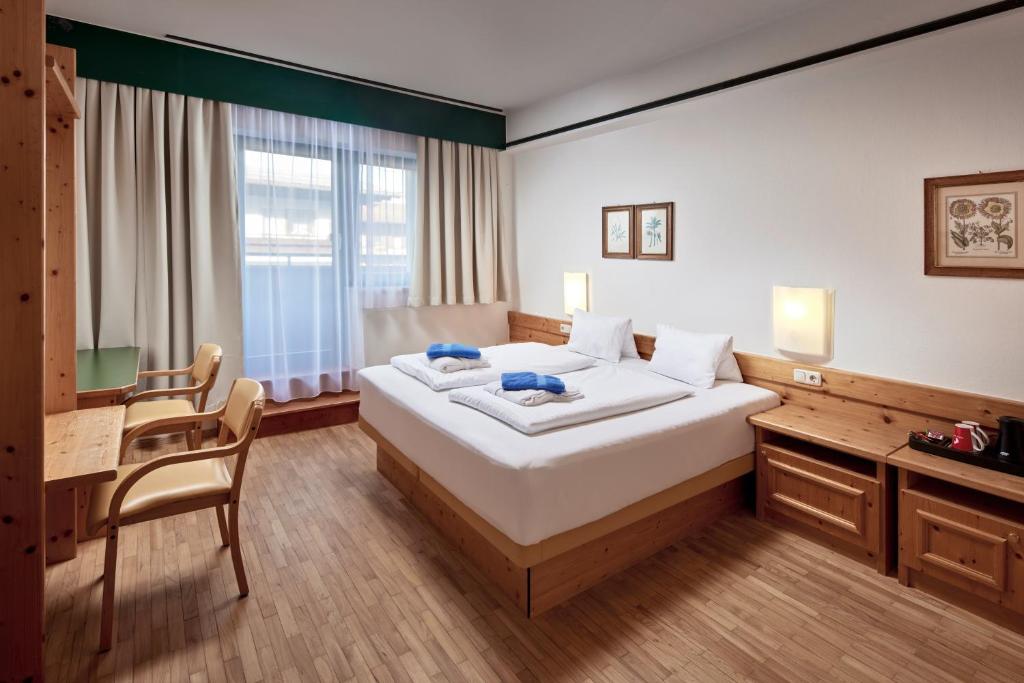 Postel nebo postele na pokoji v ubytování Sporthotel Kogler