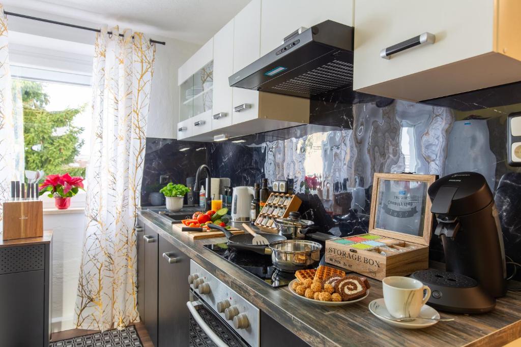 a kitchen with a counter with food on it at G.A.D.D Ferienwohnung/Glück an der Donau in Straubing