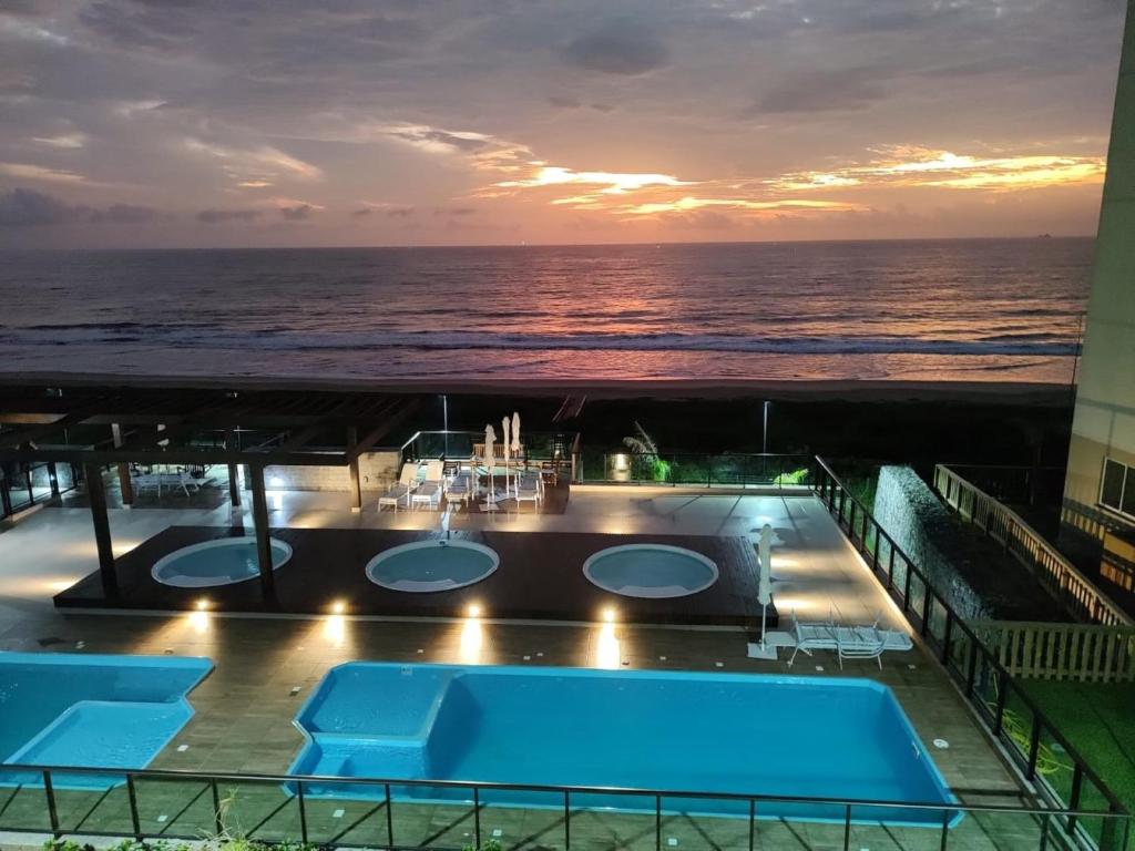 a view of the ocean from the balcony of a cruise ship at Apto Brilho do Sol - Barra Velha - SC in Barra Velha