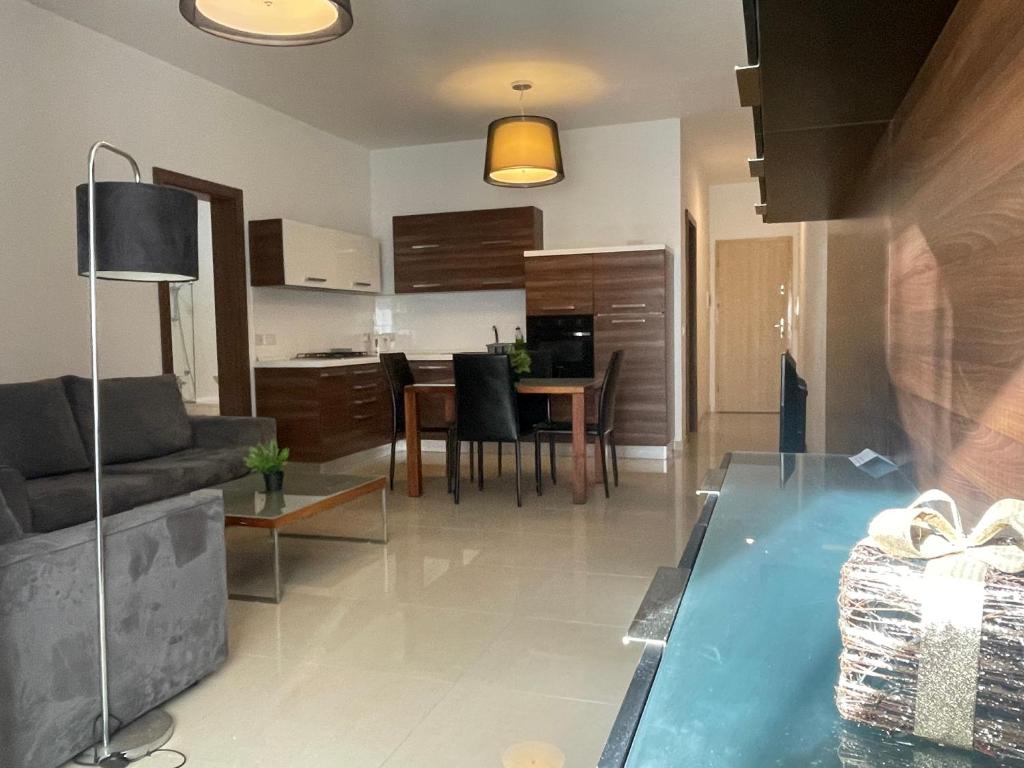 a living room with a couch and a table at Great location accommodation in St Paul's Bay