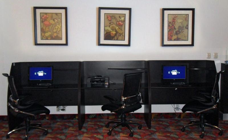 A compact business-center setup with two computer workstations.