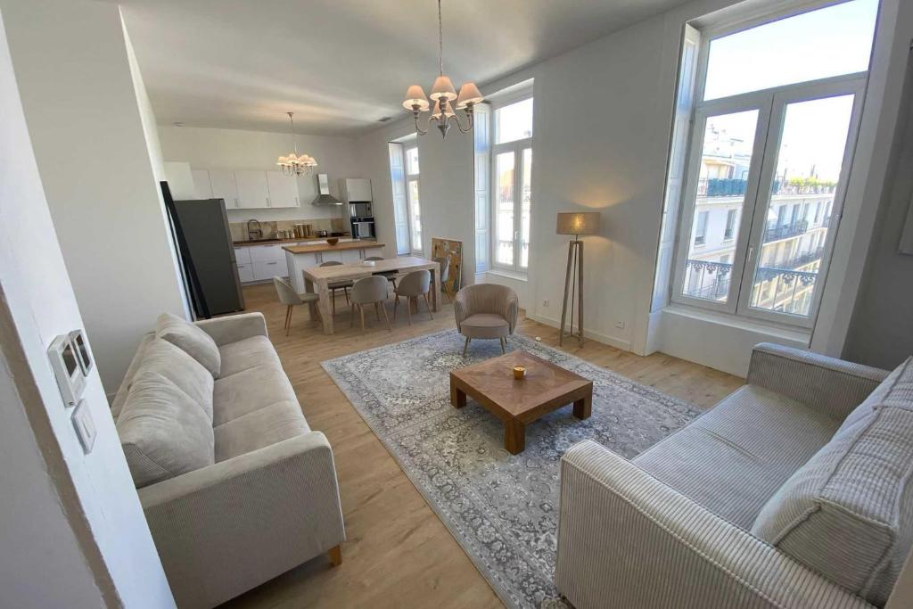 a living room with two couches and a table at Sunny luxury flat in the city centre in Montpellier