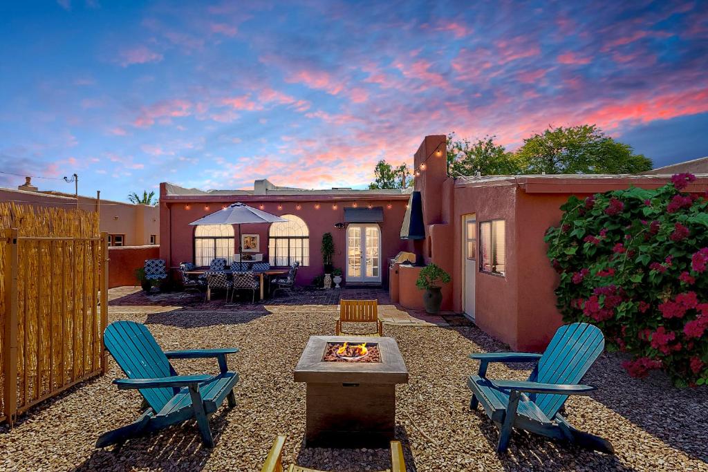 a backyard with two chairs and a fire pit at Charming Basement Studio 2 Blocks from the UofA in Tucson