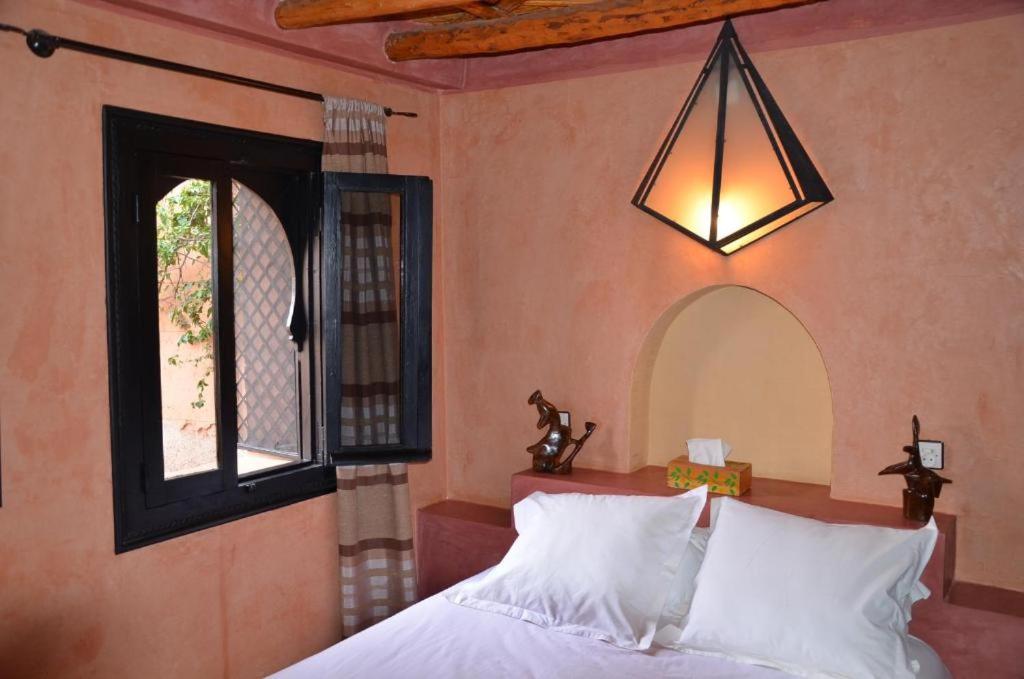 a bedroom with a bed and a window at VILLA TATA MARIE MAISON D'HOTES Marrakech in Marrakech