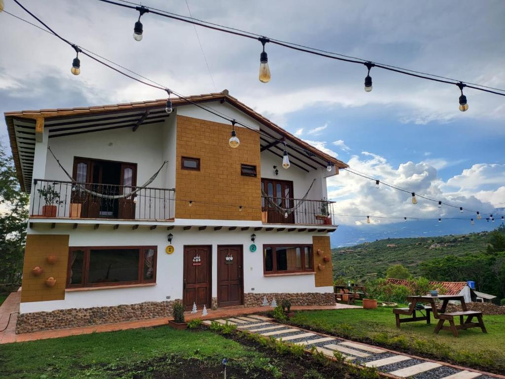 une maison avec une table de pique-nique devant elle dans l'établissement Hotel Ficus Villa de Leyva, à Villa de Leyva