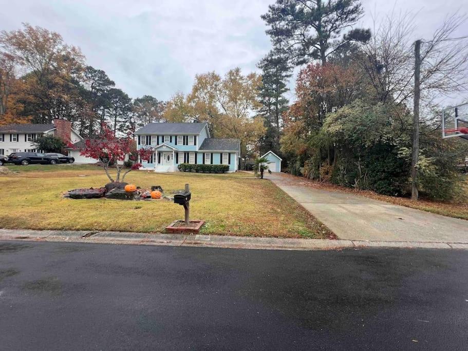 a house with a pumpkins on the lawn at Welcome to The Blue House! in Stone Mountain