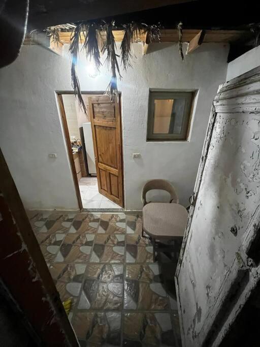a room with a door and a table and a chair at Apartment dahab in Dahab