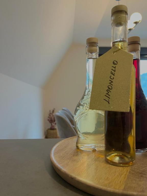 a bottle of oil on a cutting board with a tag on it at Villa Anemar in Blidinje