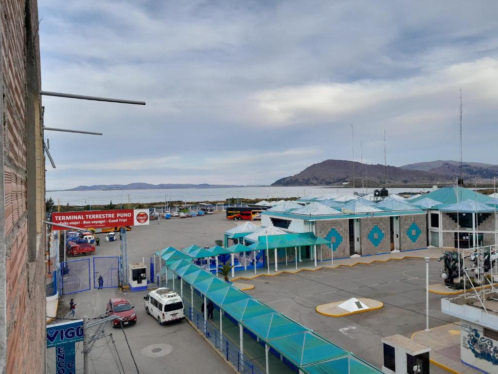 a parking lot with blue tents and cars in a parking lot at Hospedaje errante andino in Puno