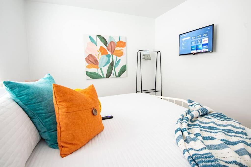 um quarto com uma cama com uma almofada laranja em Vulcan’s Hideout / Fully Equipped Kitchen / A2 em Birmingham