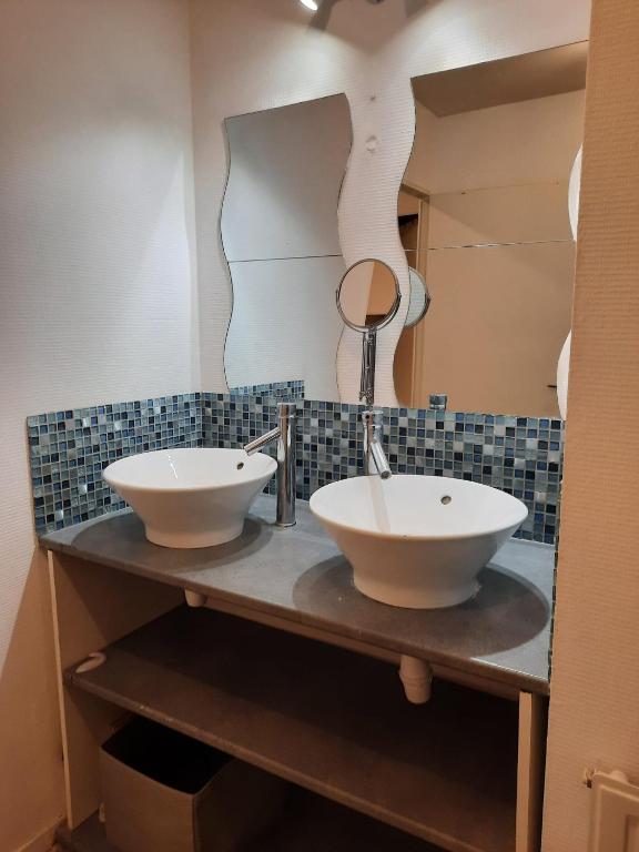 a bathroom with two sinks and a mirror at La Chambre Saint Jacques &amp; Rennes in Saint-Jacques-de-la-Lande