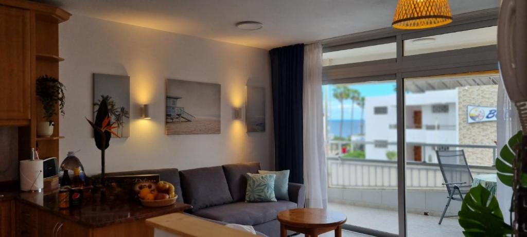 salon z kanapą i dużym oknem w obiekcie Apartment with sea view close to dunes of playa del ingles w mieście San Bartolomé