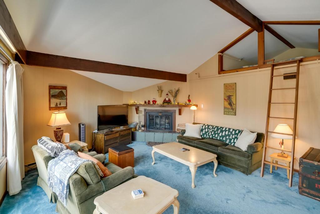 a living room with two couches and a fireplace at Bromley Mountain Escape with 2 Balconies Hike and Ski in Peru