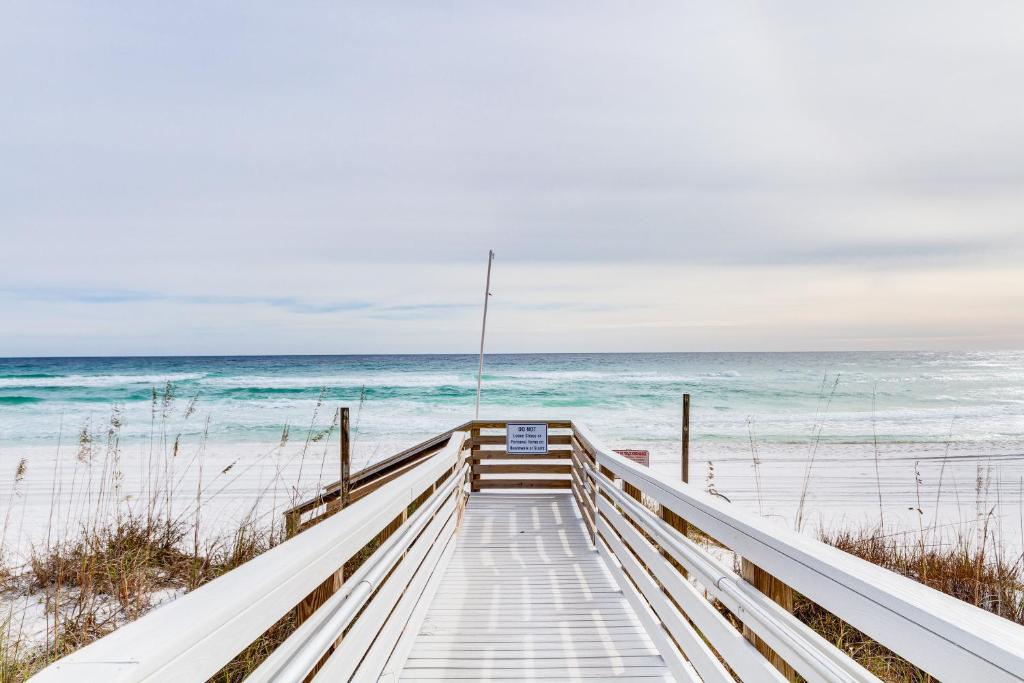 a boardwalk to the beach with the ocean in the background at Pensacola Beach Condo with Patio and Access to Beach! in Pensacola Beach