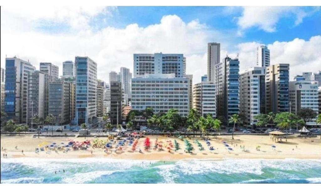 a beach with a bunch of people on it at Flat vista mar Boa Viagem in Recife