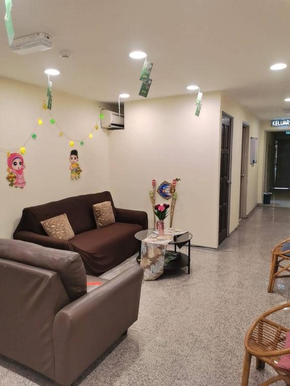A compact lounge with sofas, a small coffee table and decorative wall displays.