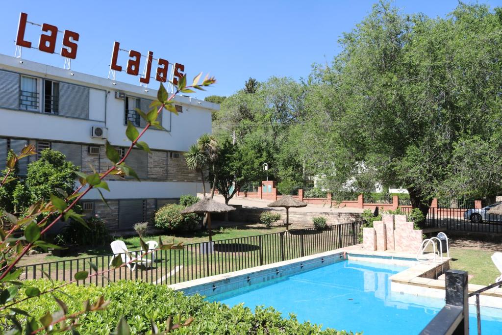 a swimming pool in front of a building at Gran Hotel Las Lajas in Villa Carlos Paz
