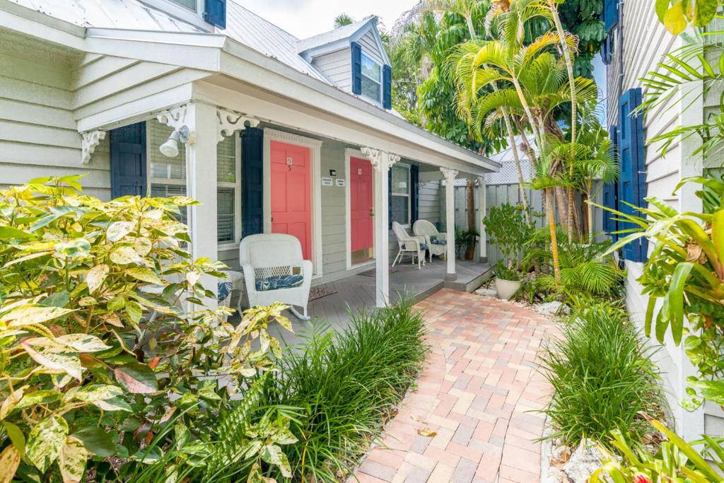a house with a red door and a patio at Old Town Garden Villas - Andros Suite in Key West