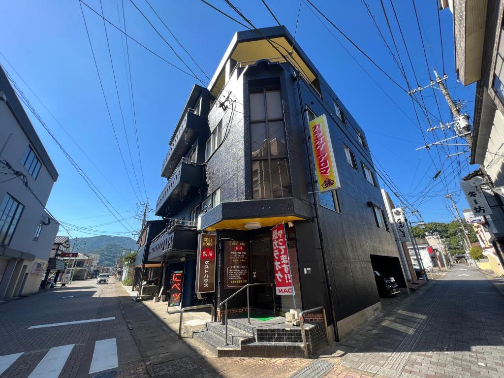um edifício ao lado de uma rua em ゲストハウス　アロマ em Ureshino