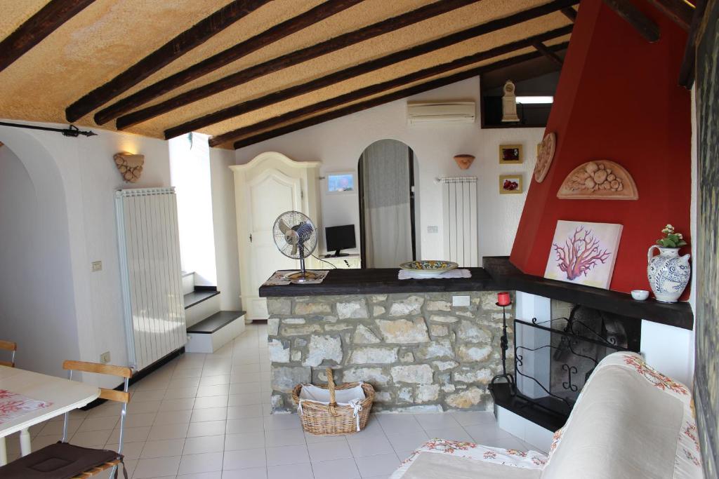 a living room with a fireplace and a stone wall at Appartamento Melograno in San Bartolomeo al Mare
