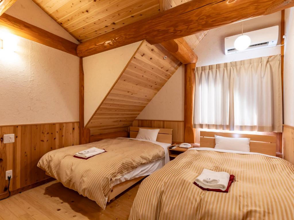 Postel nebo postele na pokoji v ubytování Tennenonsen Harunonoyu