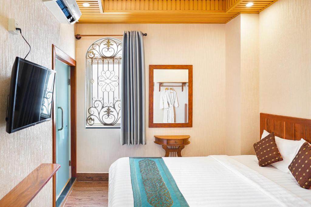 Postel nebo postele na pokoji v ubytování Phuminh Hotel Riverside