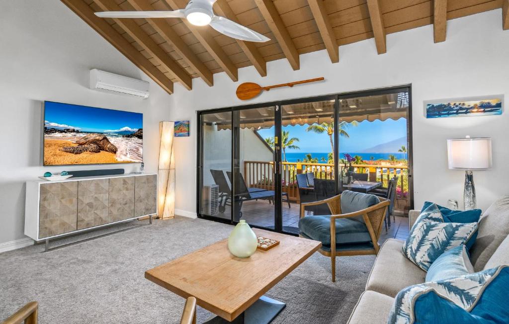 a living room with a couch and a table at Luxurious & Spacious Ocean Vistas in Wailea