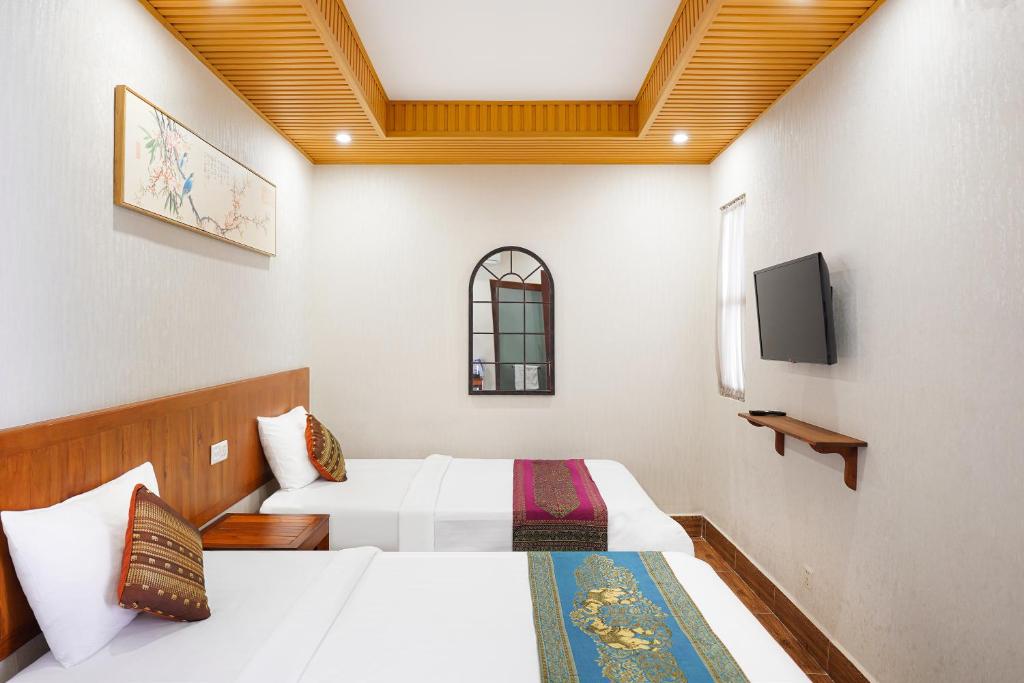 Postel nebo postele na pokoji v ubytování Phuminh Hotel Riverside