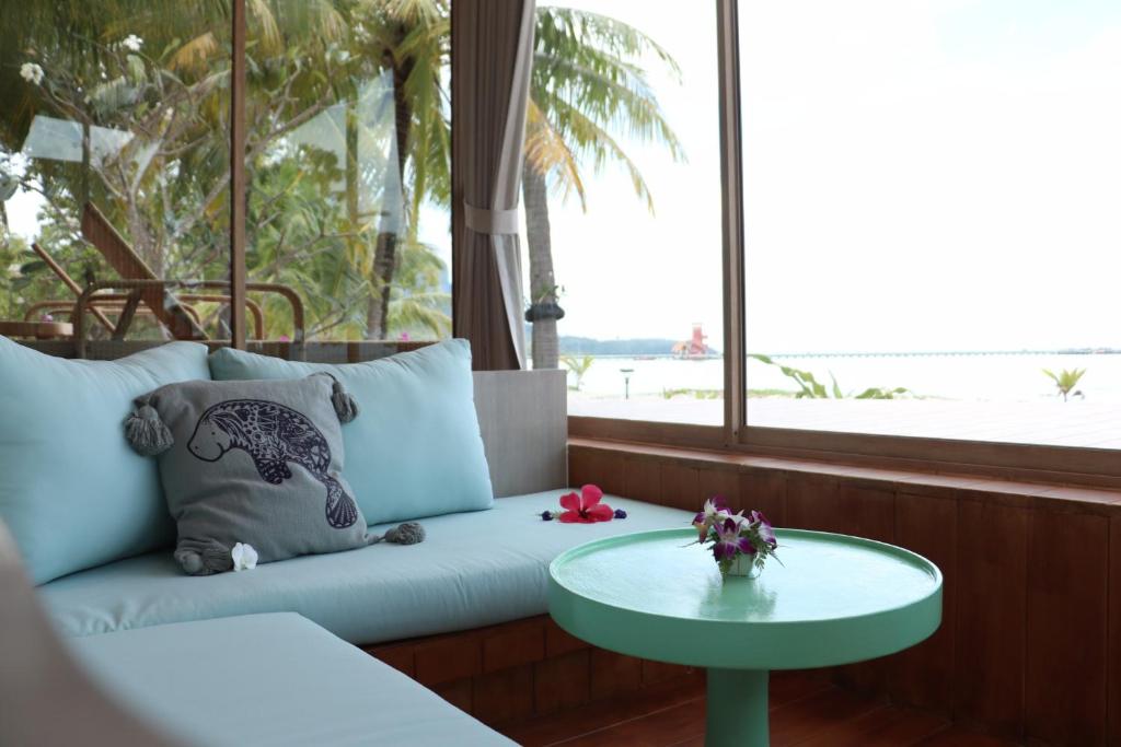 a living room with a couch and a table at Koh Mook Sivalai Beach Resort in Ko Mook