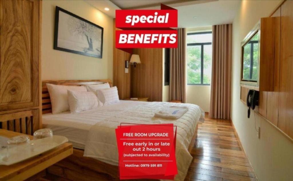 a hotel room with a bed and a sign that reads special benefits at Senkotel Nha Trang Managed by NEST Group in Nha Trang