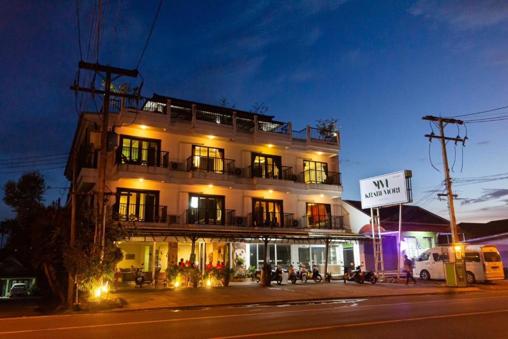 un edificio iluminado en una calle de la ciudad por la noche en KRABI MORE HOTEL, en Klong Muang Beach