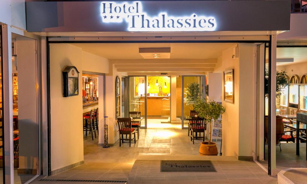 a restaurant entrance with a sign that reads hotel thinkers at Thalassies in Limenaria