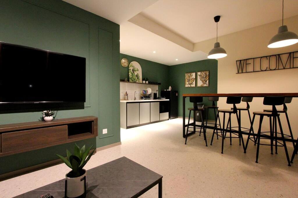 a living room with a flat screen tv and a bar at KonZept House for 14pax #5minwalk Jonker@Heritage in Melaka