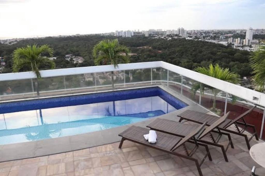 a swimming pool on the roof of a building at Flat Manaus Hotéis Millenniun in Manaus