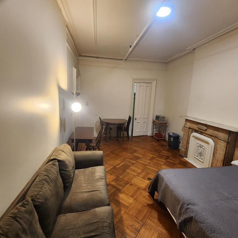 a living room with a couch and a table at New York City Guest House 2 in New York