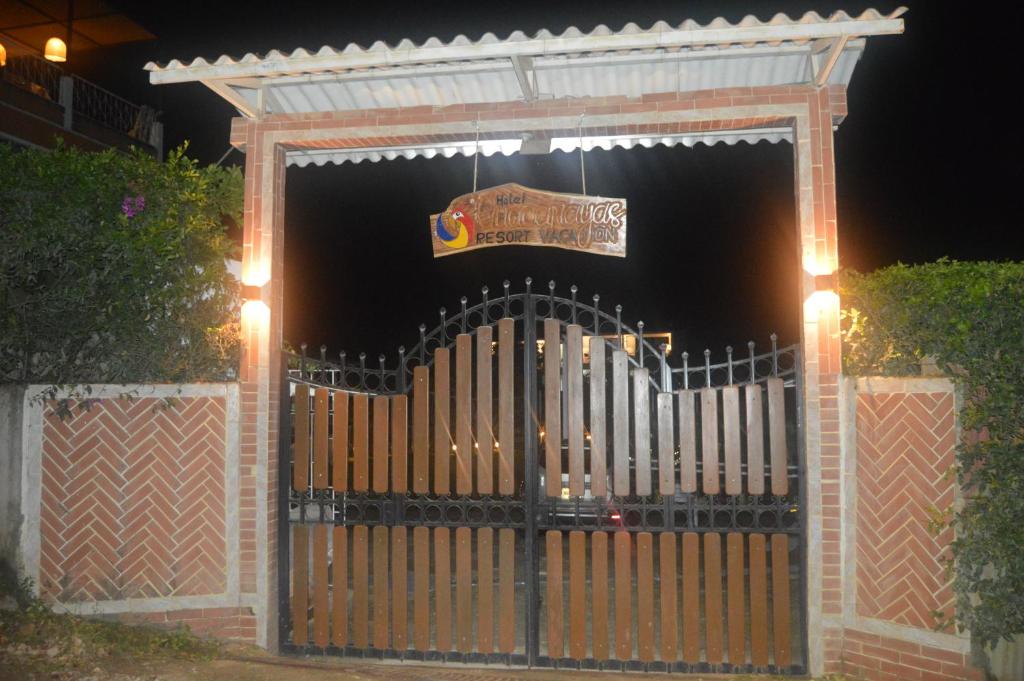 a gate at night with a sign on it at Guacamayas Resort Vacation in La Mesa