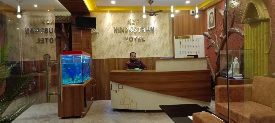 Een man aan een toonbank in een winkel met een aquarium bij New Hindusthan Hotel in Siliguri