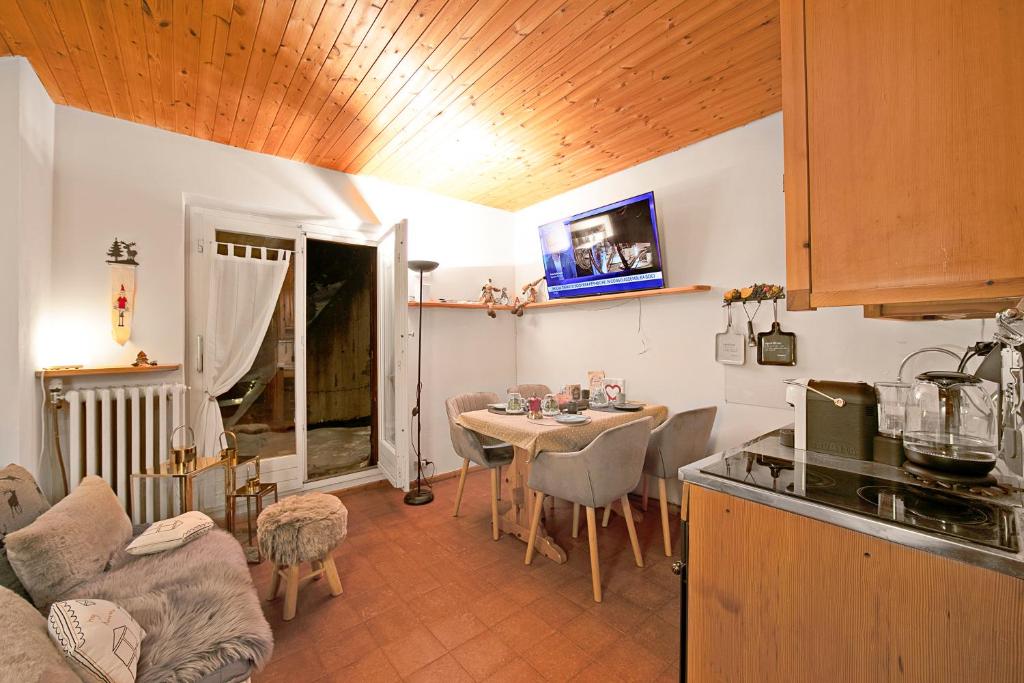 a kitchen and living room with a table and chairs at Chaberton Romantic Retreat - Happy Rentals in Claviere