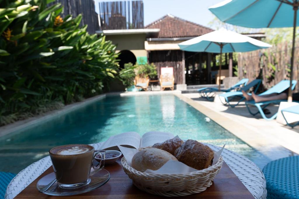 a table with a basket of bread and a cup of coffee at Wasabi in Canggu