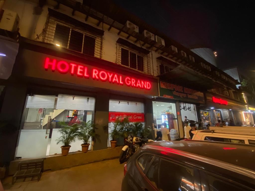 a hotel royal grand on a street at night at Hotel Royal Grand - Near Mumbai International Airport in Mumbai