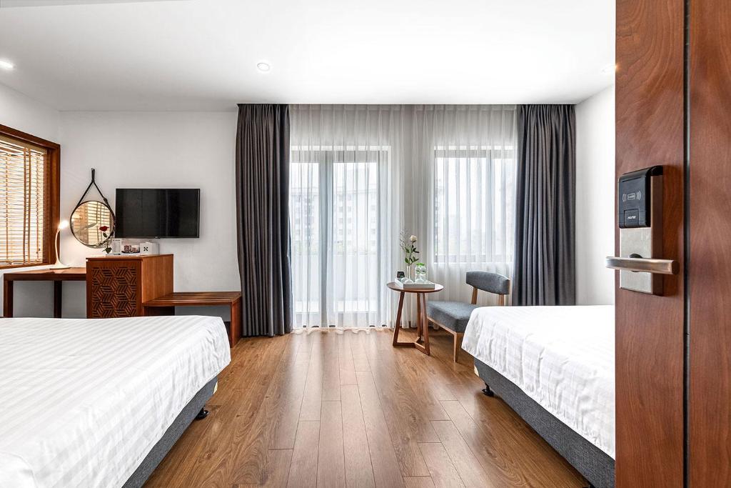 Postel nebo postele na pokoji v ubytování 22Land Classic Suites